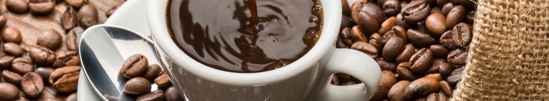 Kaffeebohnen und Kaffee in einer Kaffeetasse mit Löffel